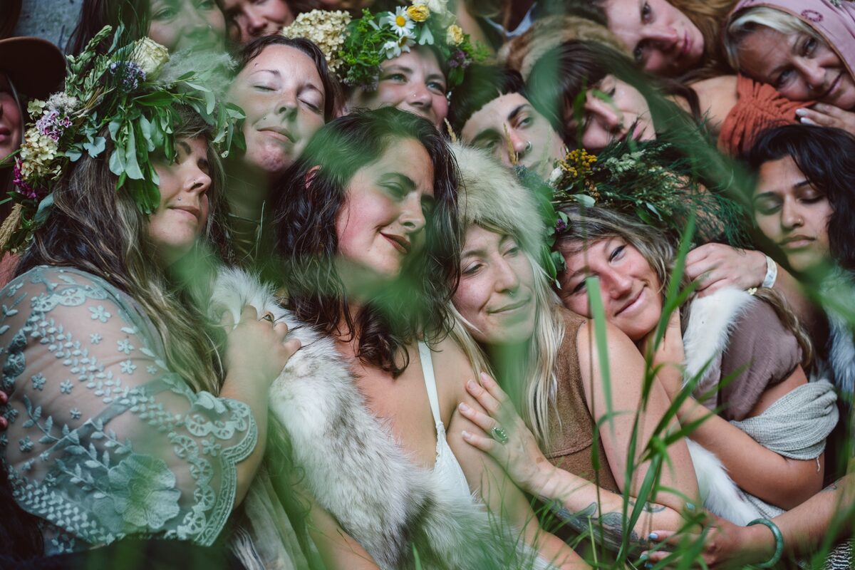 Women gathered close, flower crowns and soft presence