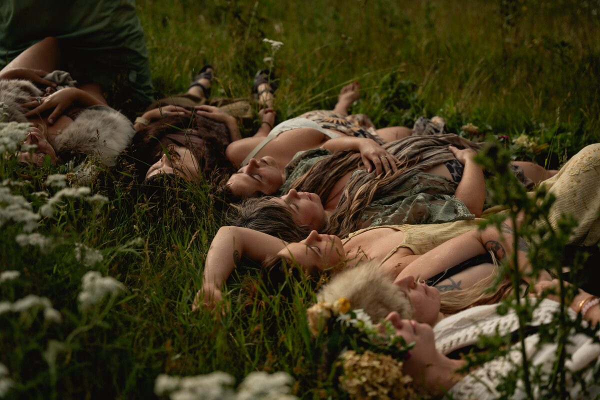 Women resting together in the grass