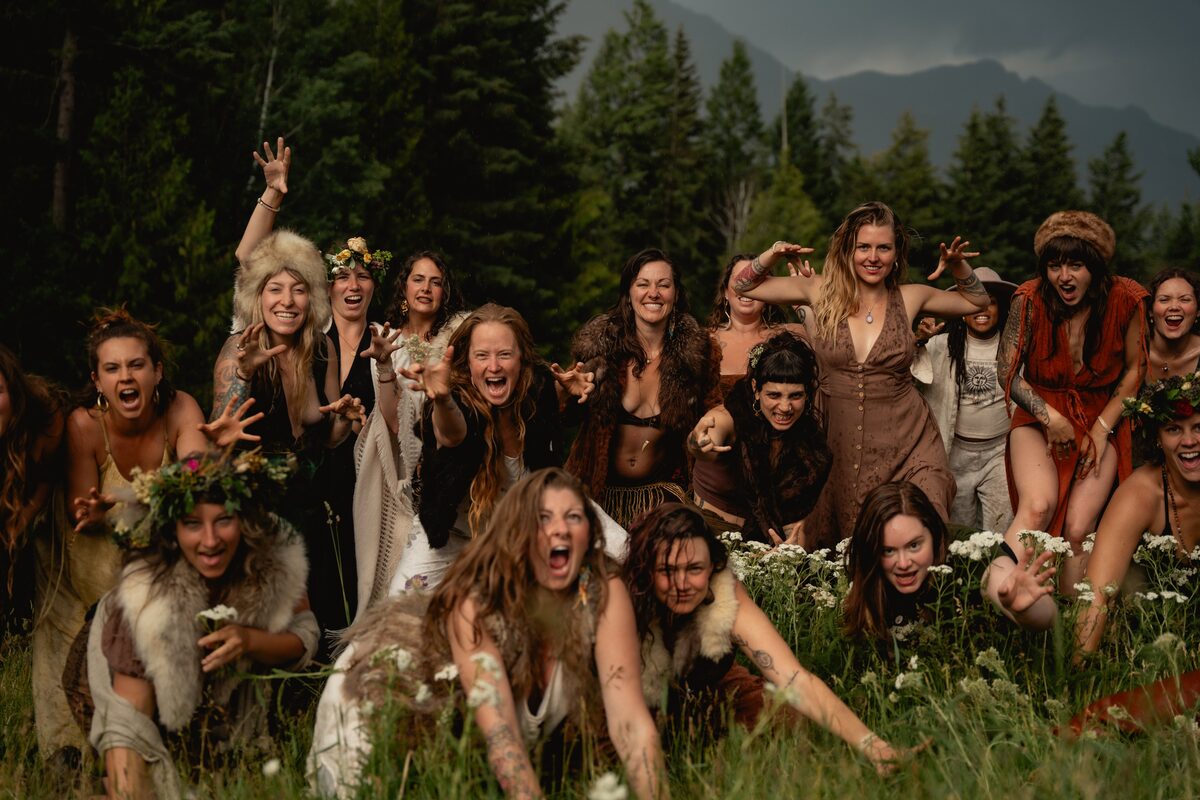 Women in wild, playful expression in a mountain field